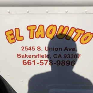 the shadow of a man on the side of a truck