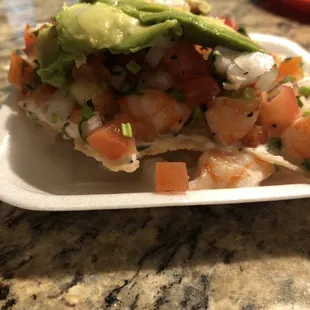 Ingredients are piled on to the tostada! So fresh!