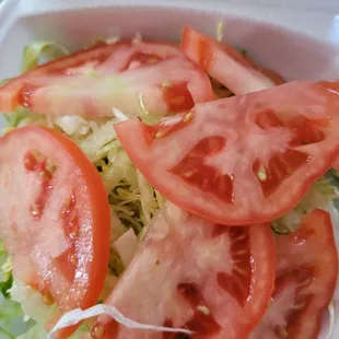 tomatoes and lettuce in a styrofoam container