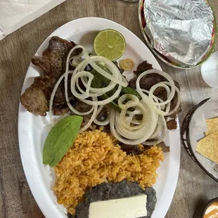 Carne asada, with rice and beans, onions, jalapeño, and avacado.