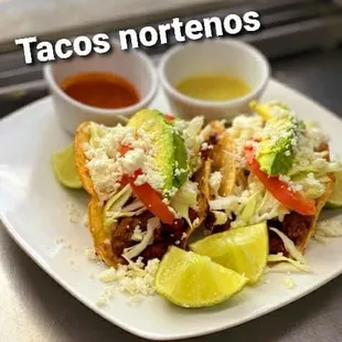 Tacos Norteños: regular corn tortilla, refried beans, mozzarella cheese, lettuce, tomato, avocado, fresh Mexican cheese