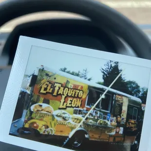 Photo of a polaroid of the taco truck - look for the flashing lights!