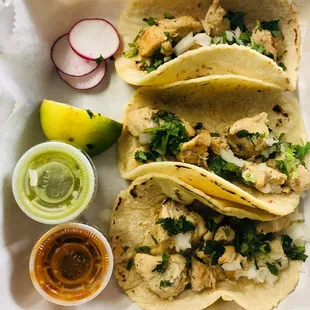 three tacos on a styrofoam container