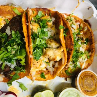 three fish tacos on a paper plate
