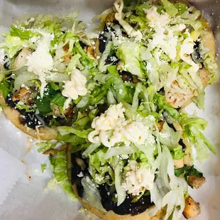 a close up of a sandwich with lettuce and cheese