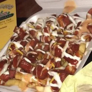 a tray of hotdogs and a tray of nachos