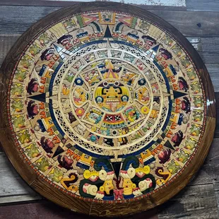 a circular mosaic on a wooden wall