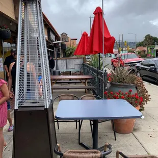 a patio with tables and umbrellas