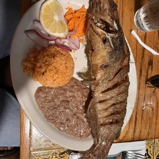 Fried Whole Fish with beans, rice and flour tortilla.