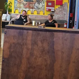 waitress taking a little break to check her phone messages and to chat while i'm sitting there with my credit card up in the air.