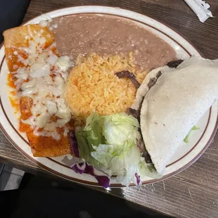 Enchila and taco with rice and beans lunch special