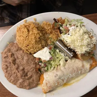 Enchilada, crunchy taco of shredded beef. Rice and beans
