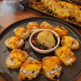 Jojo Roll (shrimp, crab, cucumber, avocado, cream cheese, Monterey Jack cheese, bacon, orange &amp; eel sauce, togarashi.