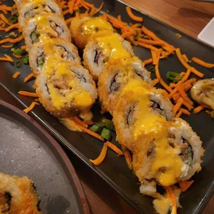 Cordon Bleu Roll (Beef, chicken, bacon, avocado, cucumber, Monterey jack cheese, cream cheese, orange &amp; eel sauce).