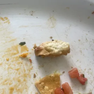 Found this in the nacho.. (looks like a piece of bread from a previously consumed dish) this indicates certain practices