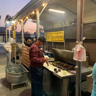 a man preparing food on a grill