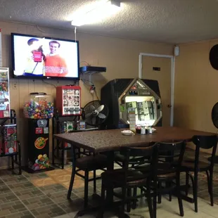 a table and chairs in front of a television