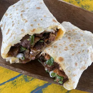 Asada Burrito- 12' tortilla, Asada Steak, melted cheese, beans, onions and cilantro.