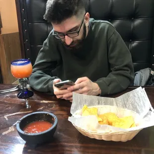 my fiancé - pictured with chips and salsa and a margarita