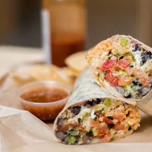 a burrito with a side of salsa