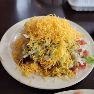 Crunchy Chicken Taco, smothered in lettuce and cheese.