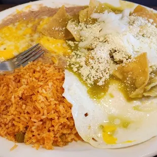 Chilaquiles en salsa verde y huevos estrellados con frijoles pintos y arroz.