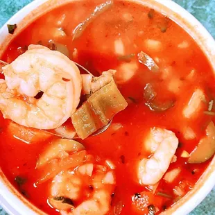 a bowl of soup with shrimp