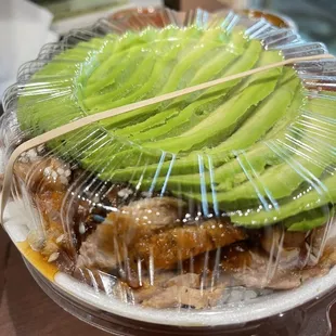 an avocado sandwich wrapped in plastic
