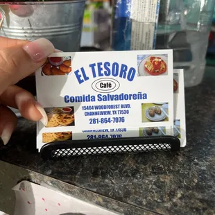 a hand holding a business card
