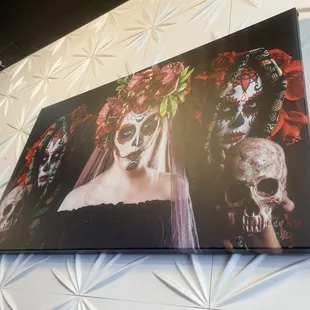 a picture of a woman with sugar skulls on her face