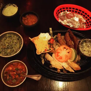 Beef and chicken fajitas, charro beans, corn tortillas and cilantro rice