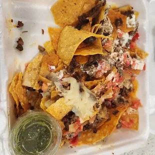 The portion of the carne asada super nachos we&apos;re throwing away.