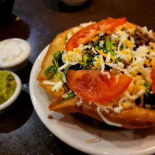 Taco Salad with side of guacamole and sour cream.