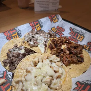 three tacos on a table