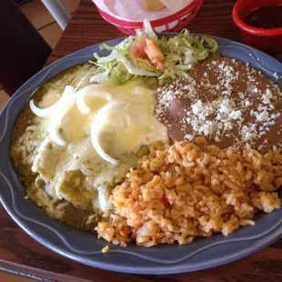 Enchiladas Suites with cream cheese , with chicken, rice and retried beans