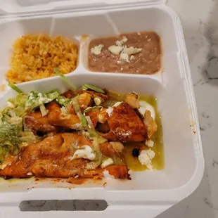 Shrimp enchiladas with beans and rice.