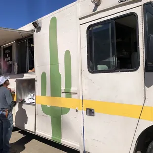 a man standing in front of a food truck