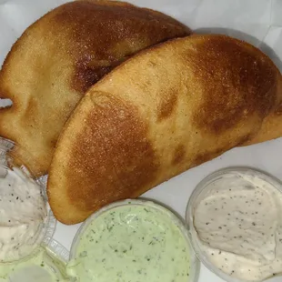 Empanadas with garlic and cilantro sauce - $4.99 each. They are very large sized
