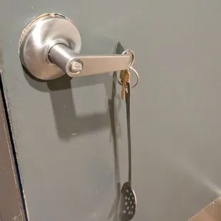 Restroom key. Not sure why they had to put it on a spatula