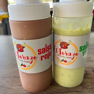 two bottles of sauce on a table
