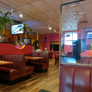 Clean dining room with plexi separators between booths