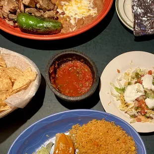 Clockwise from top: Carnitas, Tostada, Tamal, Chips and Salsa