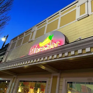 a neon sign on the side of a building