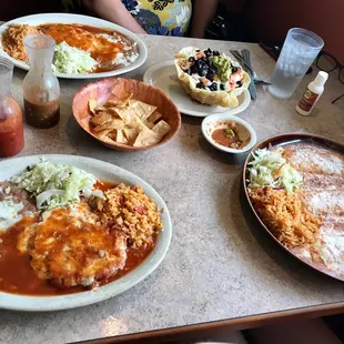 Two chile Relleno plates on the left, taco salad, and three enchiladas. Yum!