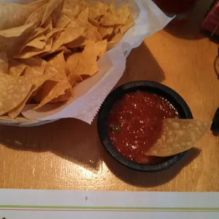a bowl of chips and a bowl of salsa
