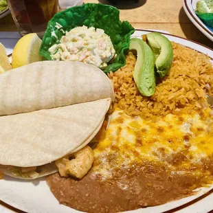Shrimp tacos with rice and beans.