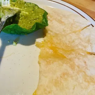 Quesadilla with guacamole and sour cream. I ate half of it by the time I took this picture.