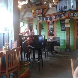 a woman sitting at a table in a restaurant