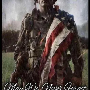 a soldier holding a flag with the words may we never forget freedom our free