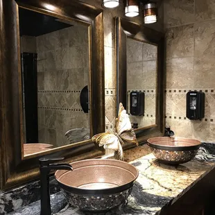 a bathroom with two sinks and a mirror
